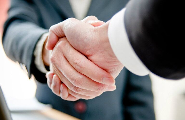 two people shaking hands on a deal