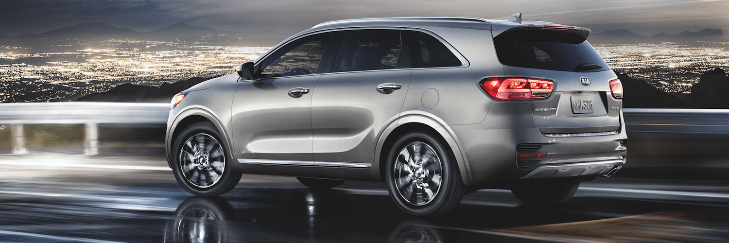 Silver Kia Sorento Driving A silver Kia Sorento driving down a highway