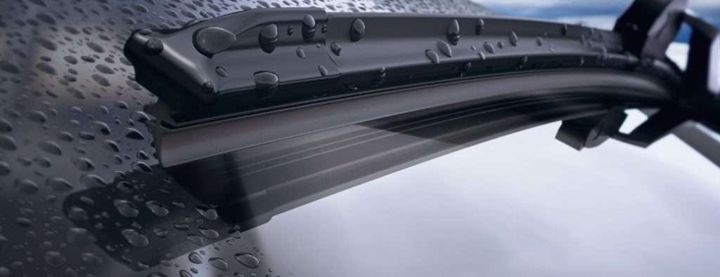 Water droplets on a car windshield wiper