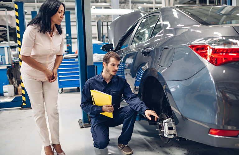 Mechanic inspecting a vehicle at a service station 