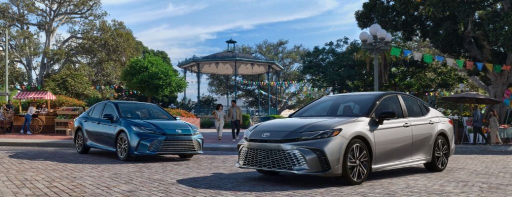 Two models of the Toyota Camry at the park