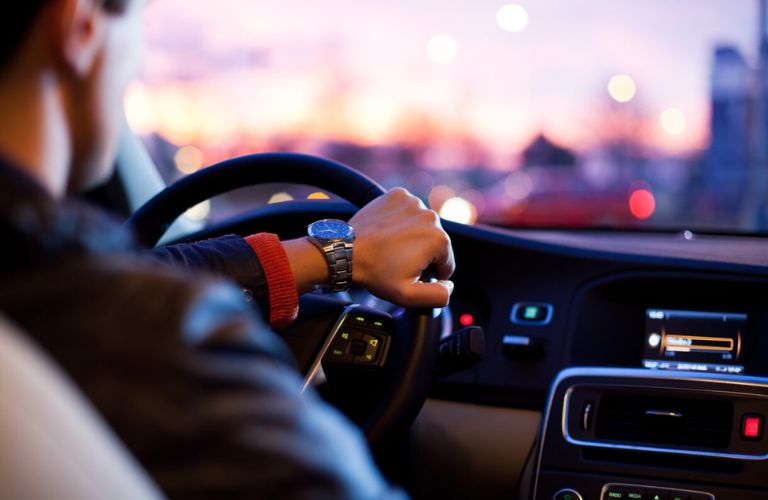 representative image of a man driving at night