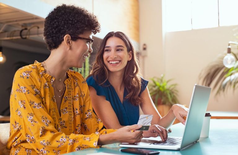 two women contemplating buying their next car