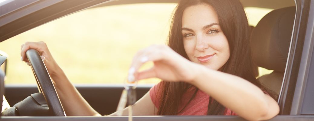 woman showing a key to the camera as she goes for a trade-in