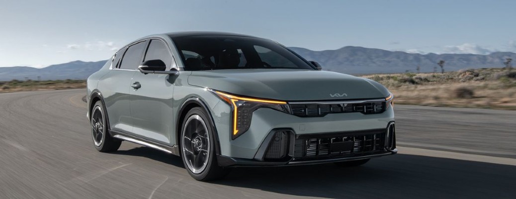 2025 Kia K4 on a road front and side angle