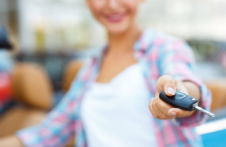 a woman holding a car key