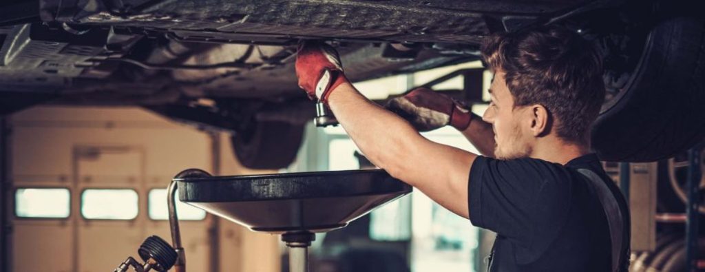 Technician performing oil change