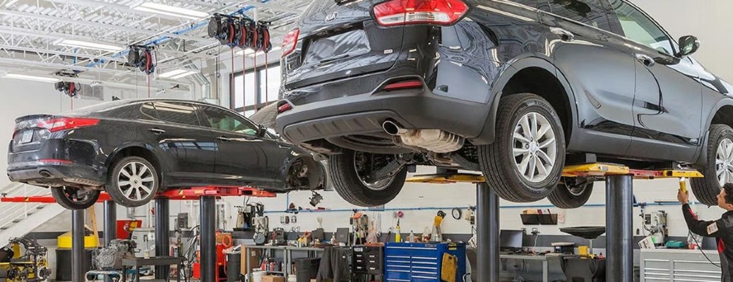 a Kia service center with cars lifted in the air