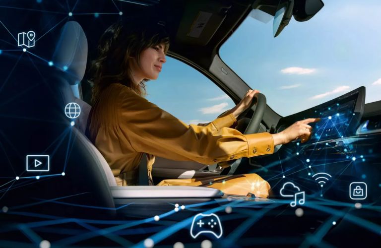 A woman driving the 2026 BMW 2 Series 230i Coupe