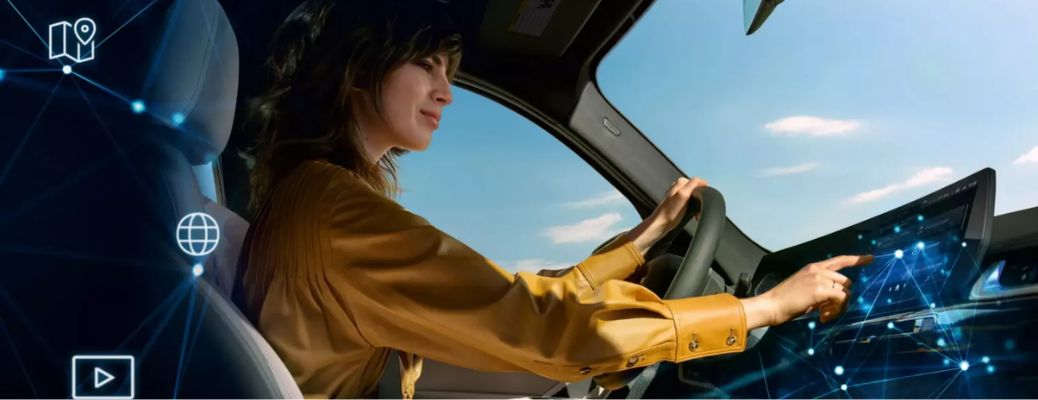 A woman driving a 2026 BMW X1