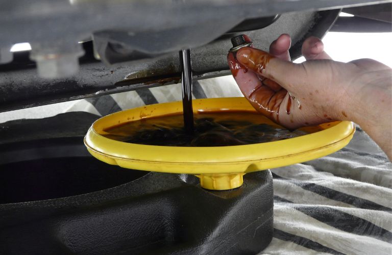 Han of a man checking oil