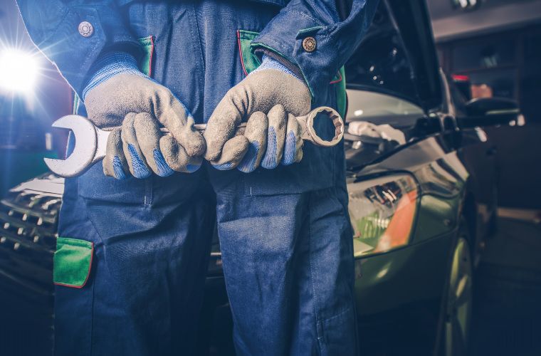 Hand of a mechanic holding a tool