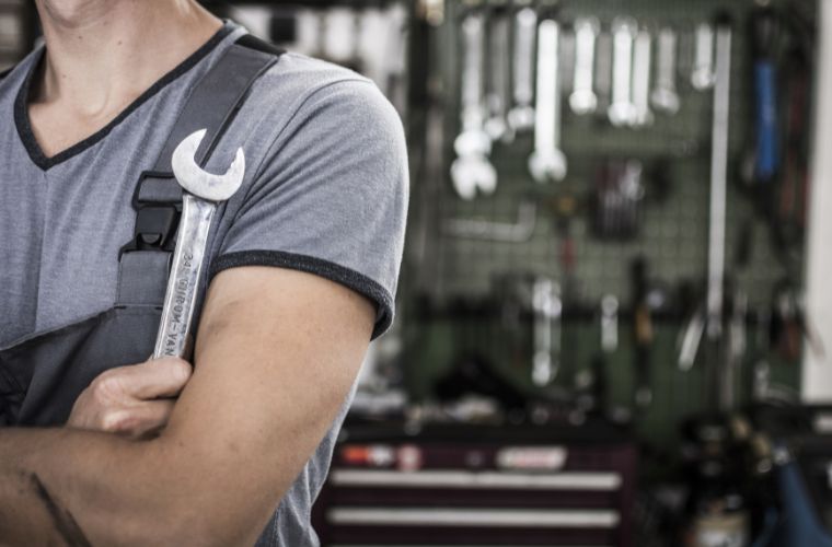 A mechanic holding a tool