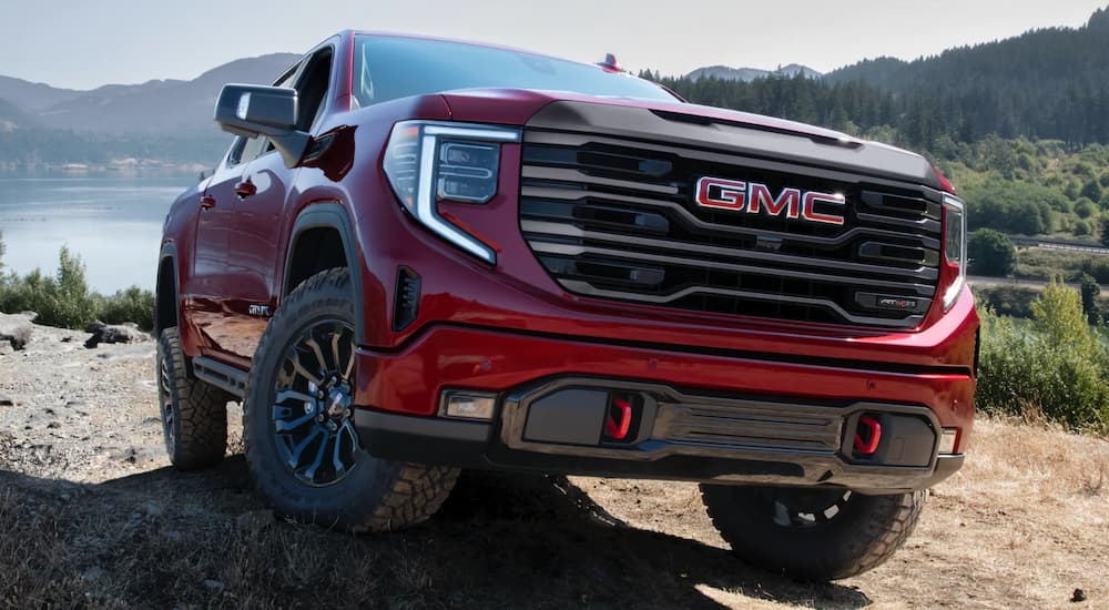 Red 2022 GMC Sierra 1500 AT4x off-roading on a rocky hill