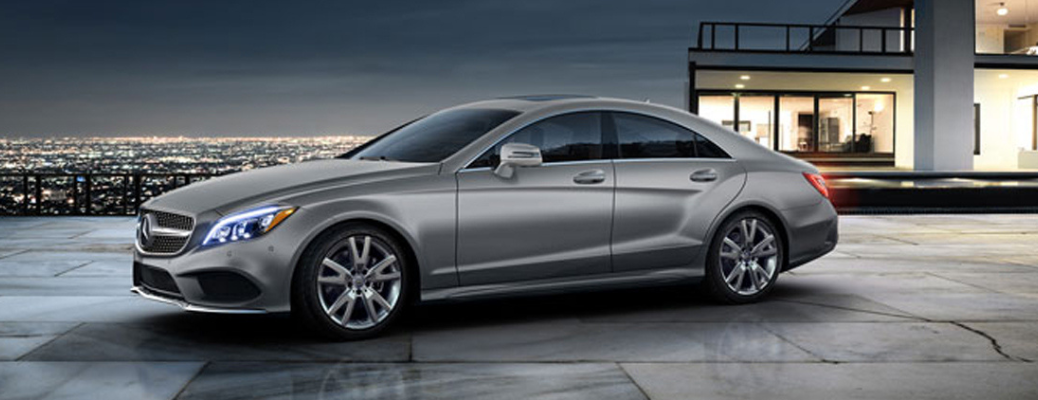 Side view of the 2018 Mercedes-Benz E-Class Coupe parked in front of a building