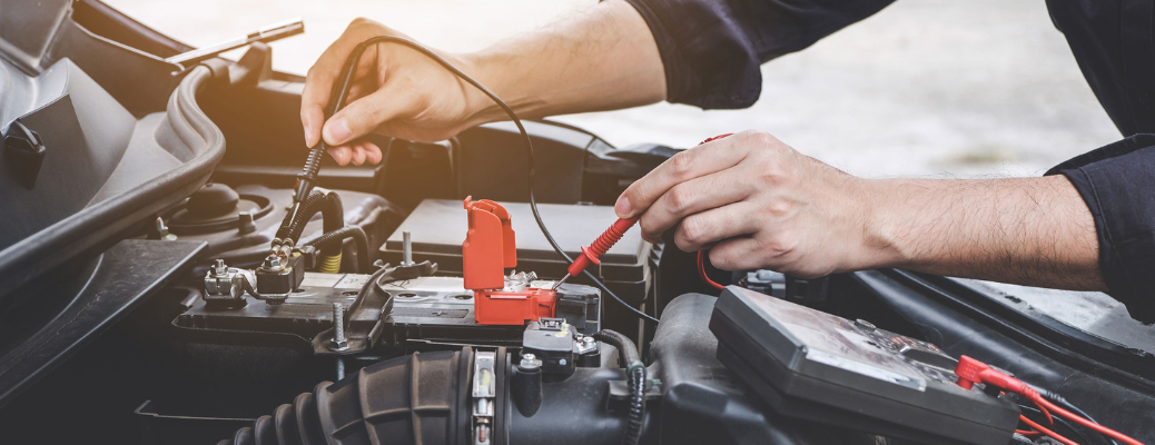 A mechanic checking a vehicle's battery