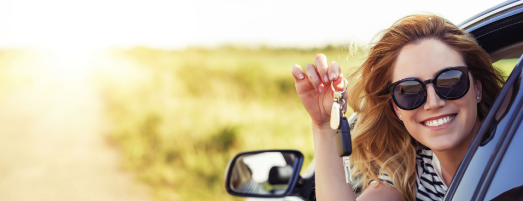 Woman showing keys from a vehicle's window