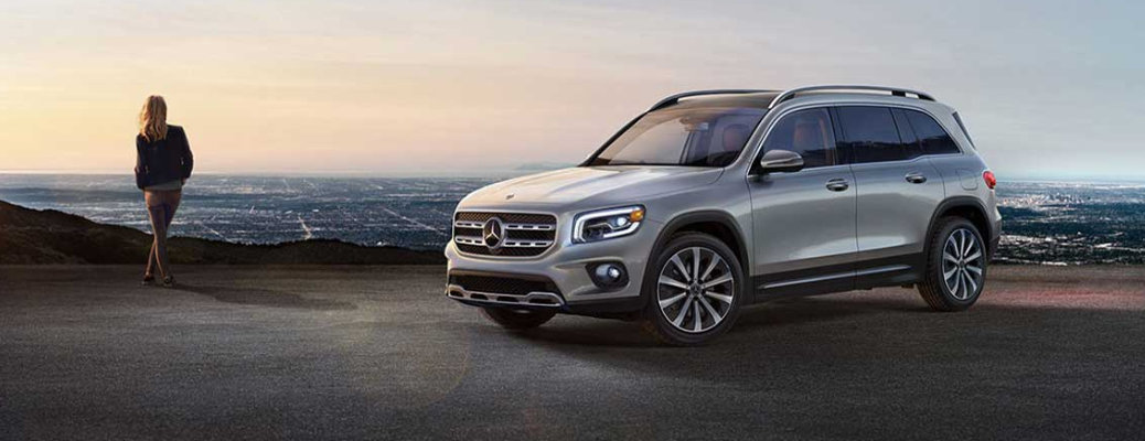 A woman standing near the 2020 Mercedes-Benz GLB