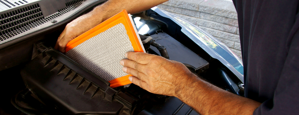 Man replacing a dirty air filter with a clean one