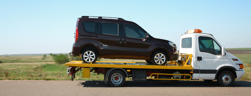 Car being towed on road