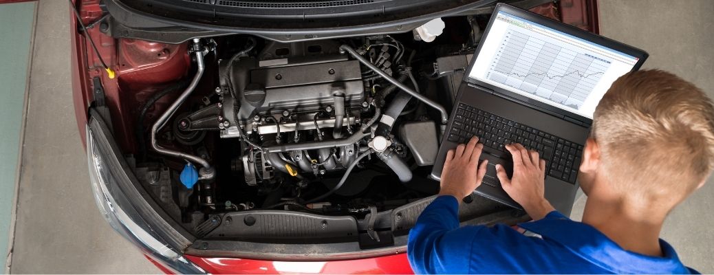 A mechanic checking the engine of a vehicle