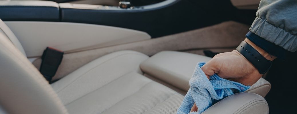 Hands of a man cleaning car seat