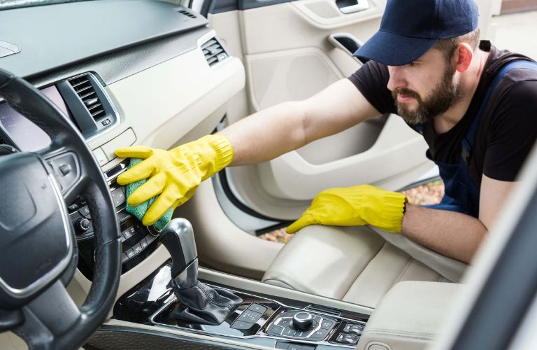 A man cleaning a vehicle