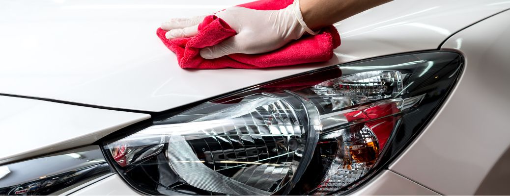 Hands of a man cleaning a vehicle