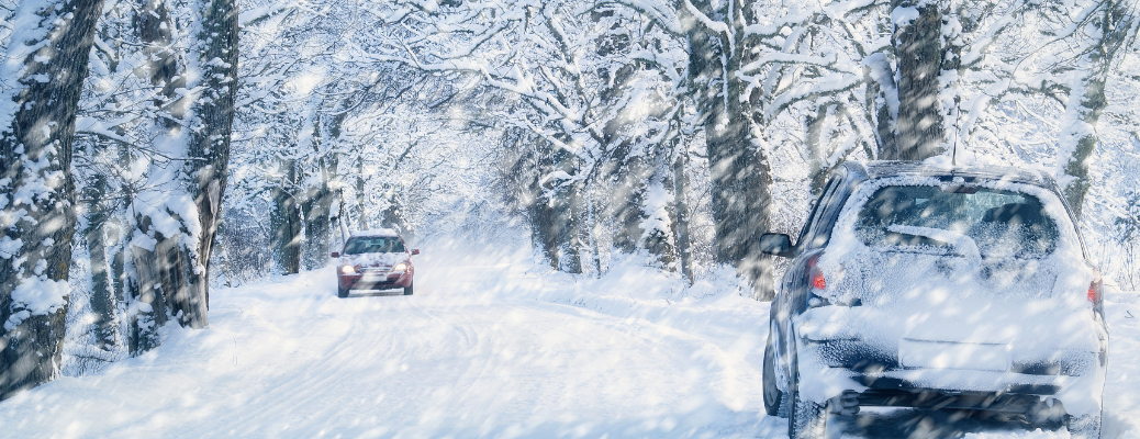 Cars on road during snowfall