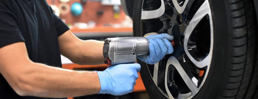 Mechanic putting air in the tire