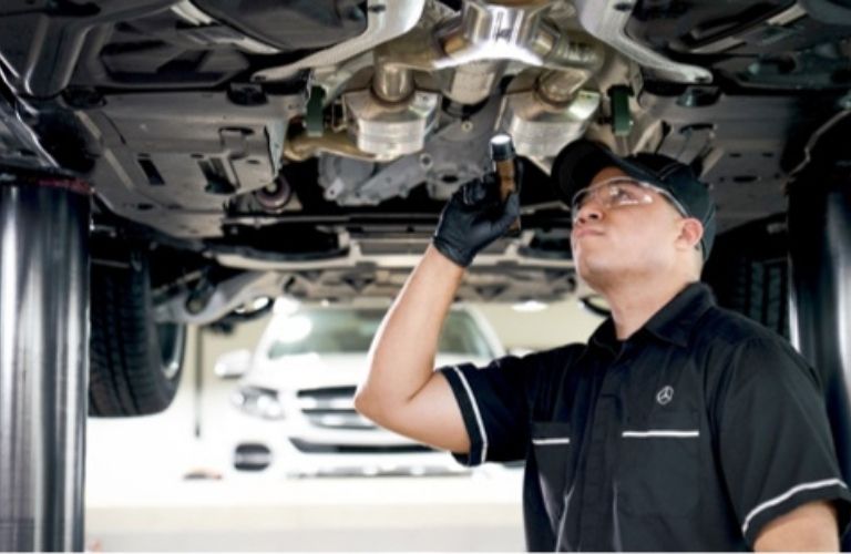 Service professional inspecting a vehicle