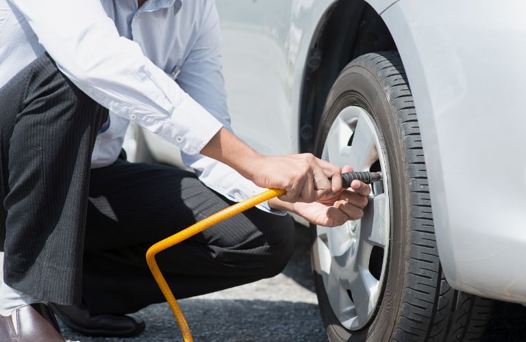 Hands of a man checking tires