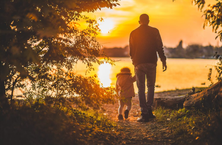 A father walking with a child