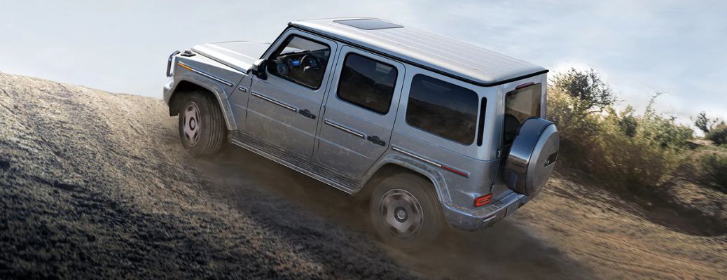 2025 Mercedes-Benz G-Class SUV moving up a sandy hill
