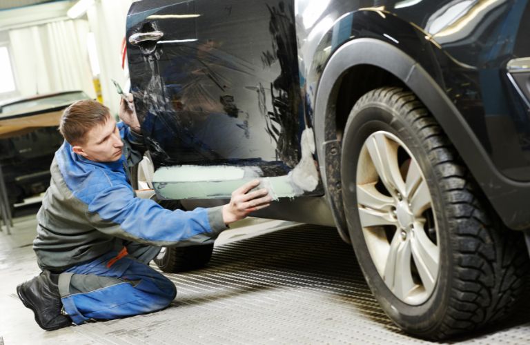 A mechanic checking a car