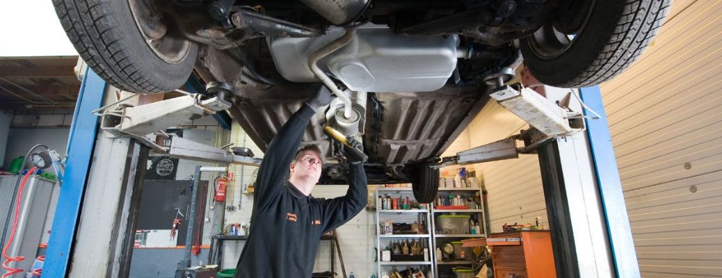representative image of a technician checking the transmission