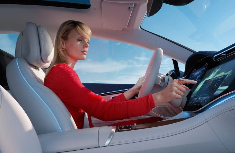 a person in a Mercedes-Benz vehicle front seat