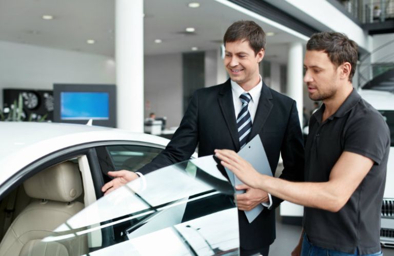 Two people opening the door of a vehicle