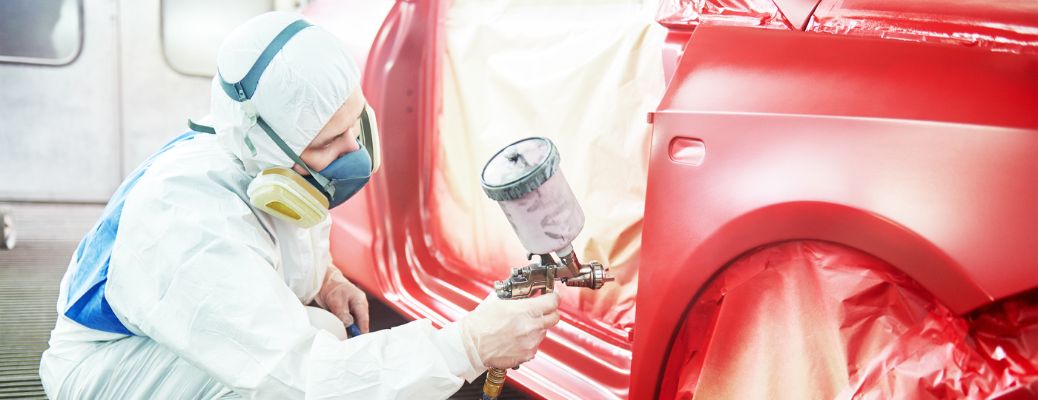 A man painting a vehicle
