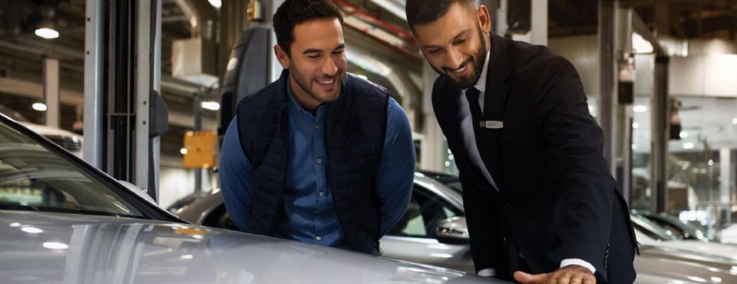 two people looking at a Mercedes-Benz