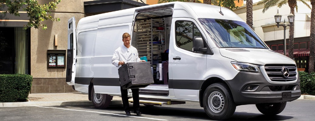 a man getting out of a Mercedes-Benz Sprinter van