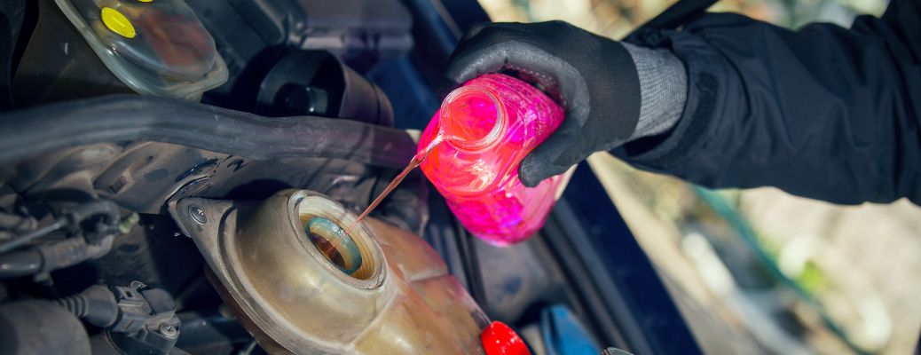 Hand of a man pouring coolant