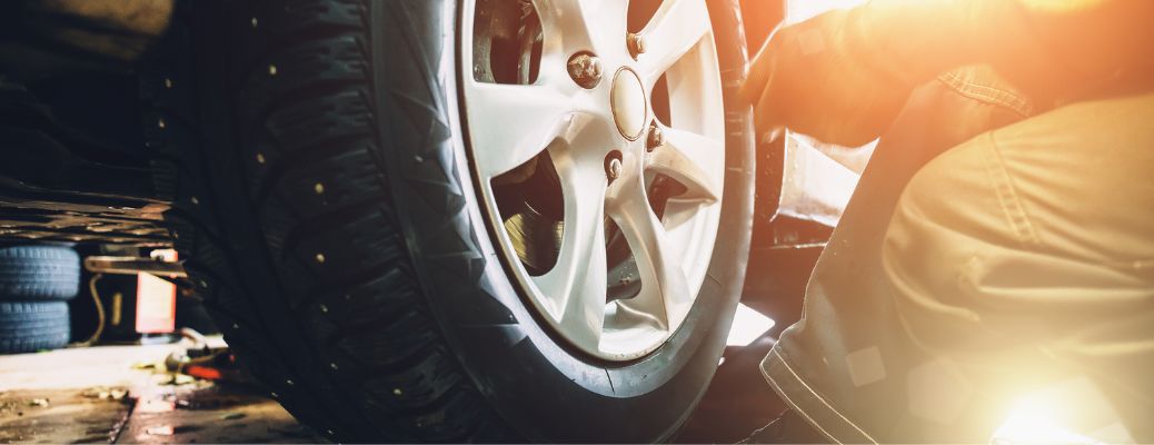 A mechanic working on a vehicle's tire
