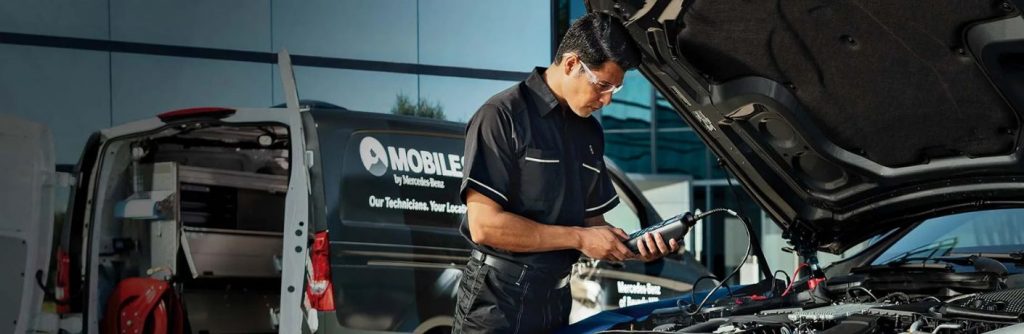 a technician working on a car battery