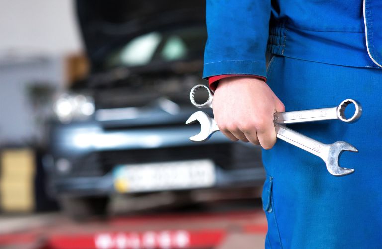Hand of a mechanic holding tools