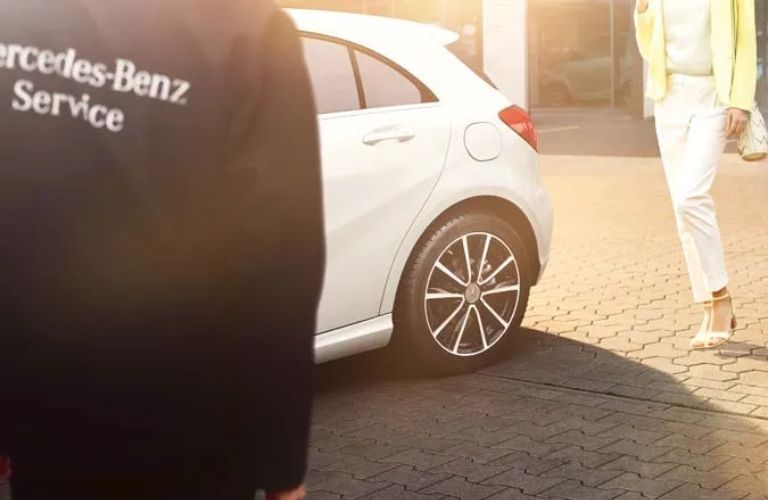 side view of a Mercedes-Benz tire with a service technician in the foreground