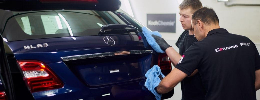 two technicians cleaning a Mercedes-Benz