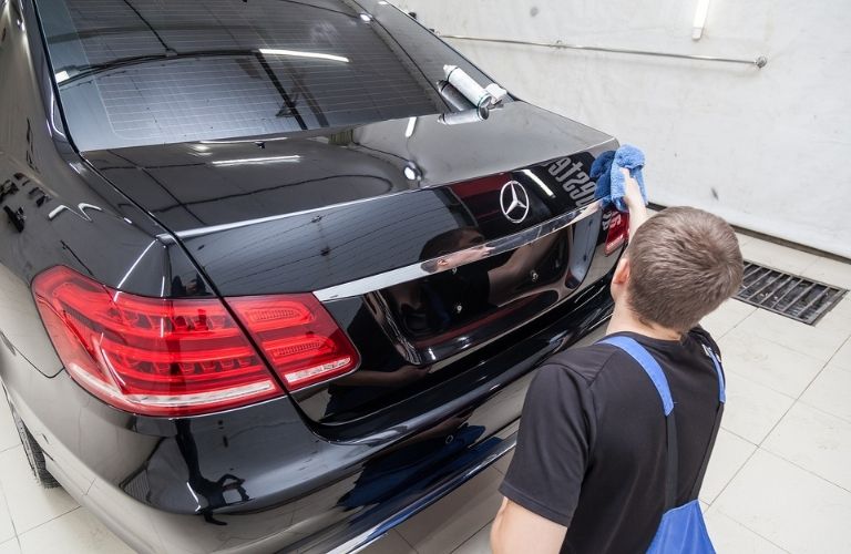 technician cleaning a Mercedes-Benz
