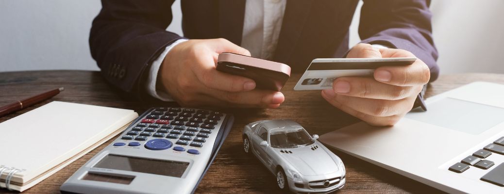 a man using his credit card to pay on the phone