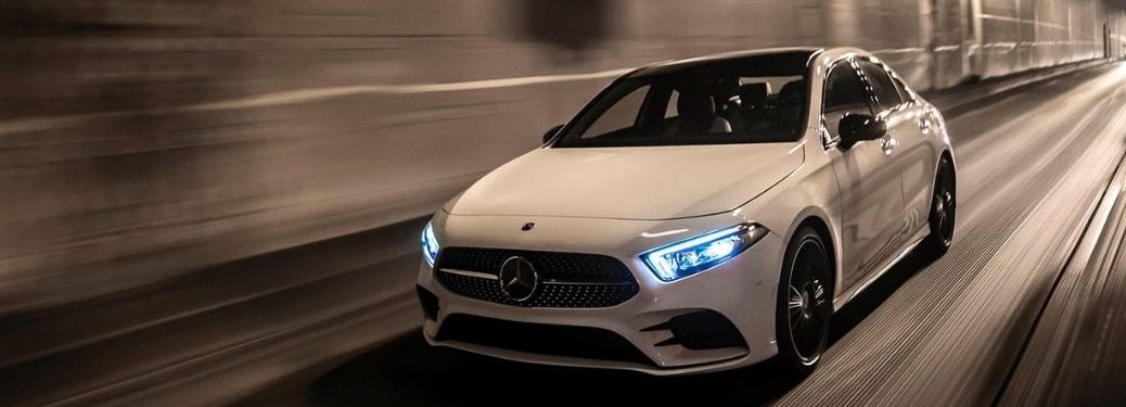 2022 Mercedes Benz A Class white with LED headlights on driving in the road